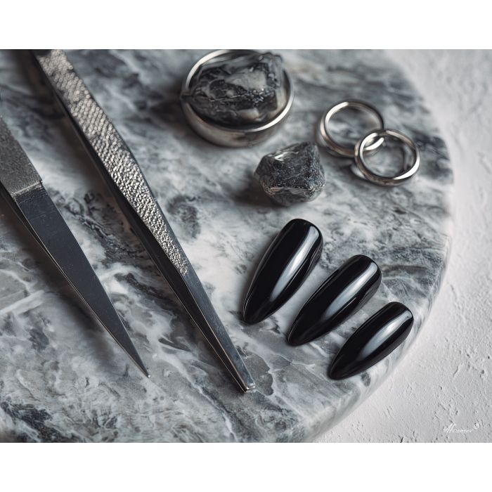 black nail polish, onyx nails, sleek manicure art, white marble still life, manicure tools painting, monochrome beauty art, bold nail scene, metal tools décor